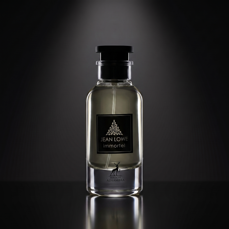 Maison Alhambra Jean Lowe Immortel — frasco sobre superficie negra reflectante con fondo carbón
